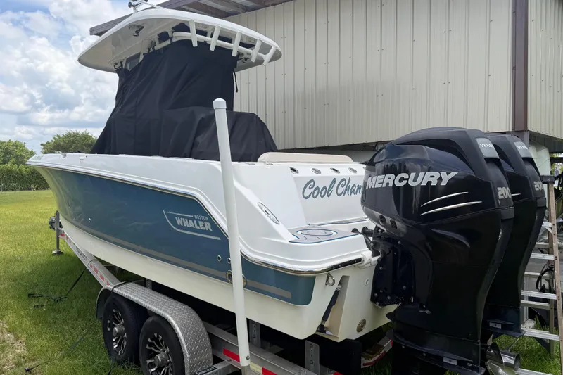 Slide: The Image of 2016 Boston Whaler 250 Outrage boat with dual Mercury engines on a trailer. - 11