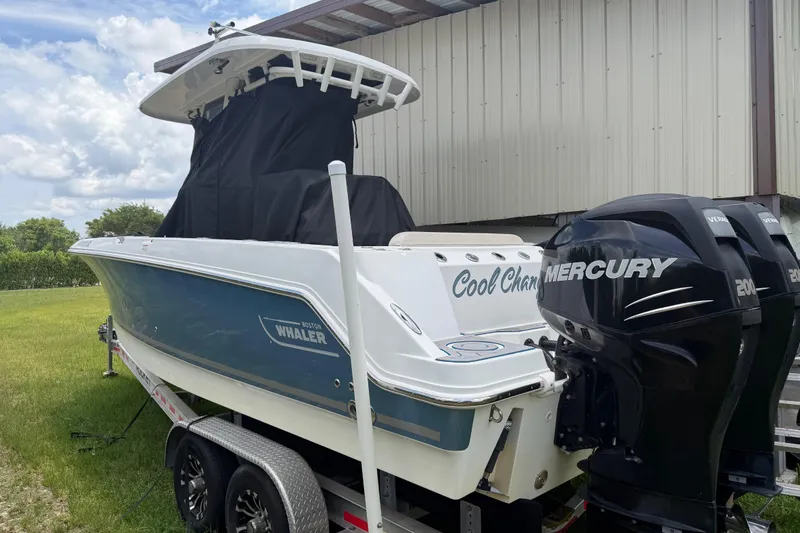 Slide: The Image of 2016 Boston Whaler 250 Outrage boat with dual Mercury engines on a trailer. - 12