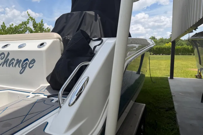 Slide: The Image of 2016 Boston Whaler 250 Outrage boat docked, showcasing sleek design and outdoor setting. - 15