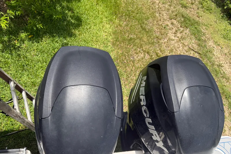 Slide: The Image of Twin Mercury outboard engines on a 2016 Boston Whaler 250 Outrage, viewed from above. - 16