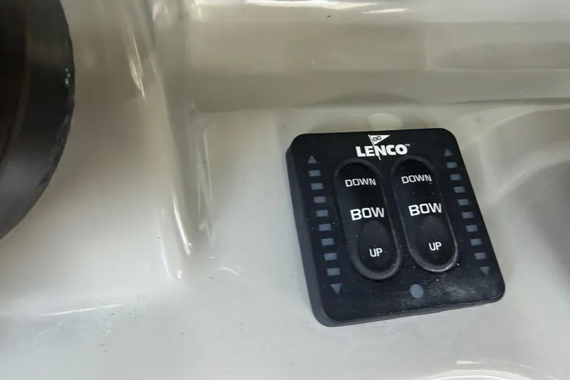 Slide: The Image of Lenco trim tab controls on a 2016 Boston Whaler 250 Outrage boat dashboard. - 21
