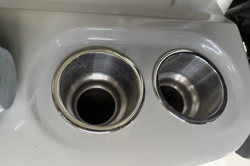 Slide: The Image of Cup holders on a 2016 Boston Whaler 250 Outrage boat, featuring stainless steel rims. - 22