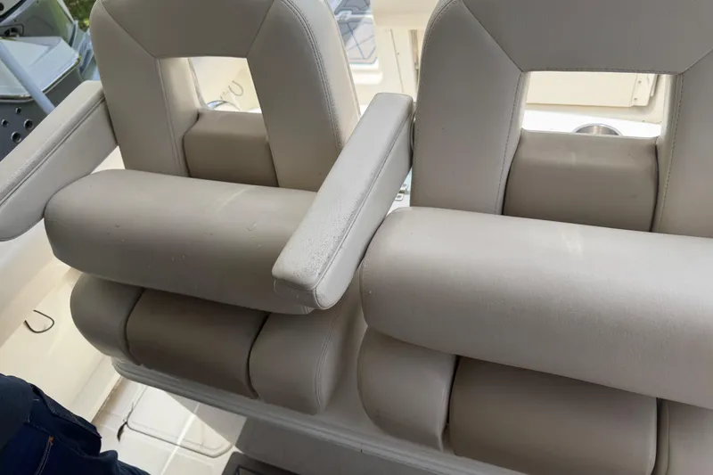 Slide: The Image of 2016 Boston Whaler 250 Outrage boat seats, featuring plush white upholstery and armrests. - 25