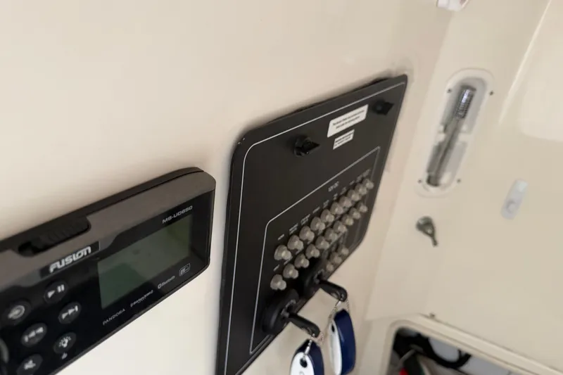 Slide: The Image of Control panel and audio system on a 2016 Boston Whaler 250 Outrage boat. - 33