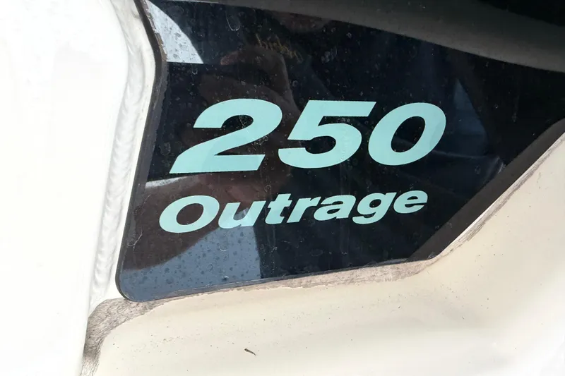 Slide: The Image of Close-up of 2016 Boston Whaler 250 Outrage boat model name on hull. - 34