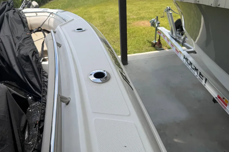 Slide: The Image of 2016 Boston Whaler 250 Outrage boat on trailer, partially covered, parked on concrete. - 36