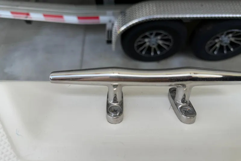 Slide: The Image of Stainless steel cleat on 2016 Boston Whaler 250 Outrage boat, with trailer in background. - 38