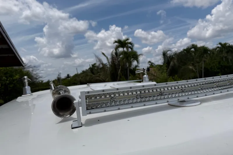 Slide: The Image of 2016 Boston Whaler 250 Outrage boat with LED light bar and horn, under a cloudy sky. - 43