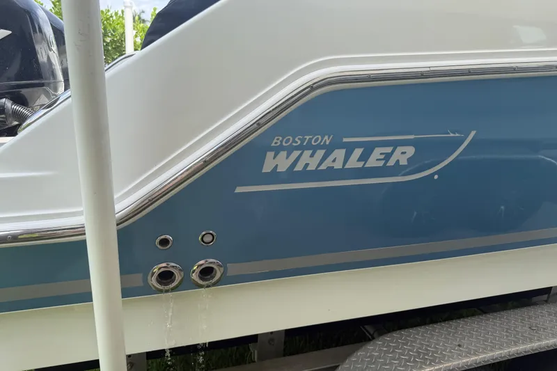 Slide: The Image of 2016 Boston Whaler 250 Outrage boat side view with logo and water drainage. - 8