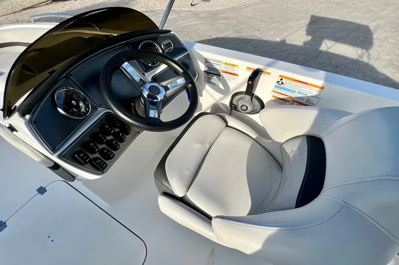 Slide: The Image of 2024 Hurricane Sundeck Sport 218 OB boat cockpit with steering wheel and seat. - 11