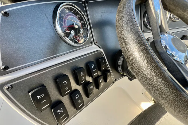 Slide: The Image of Dashboard controls of 2024 Hurricane Sundeck Sport 218 OB boat with steering wheel. - 12