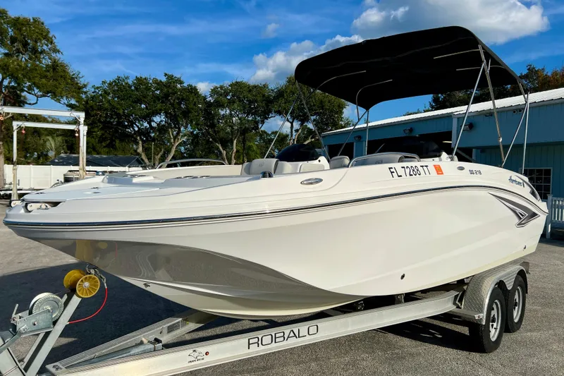 Slide: The Image of 2024 Hurricane Sundeck Sport 218 OB boat on trailer, parked outdoors. - 4