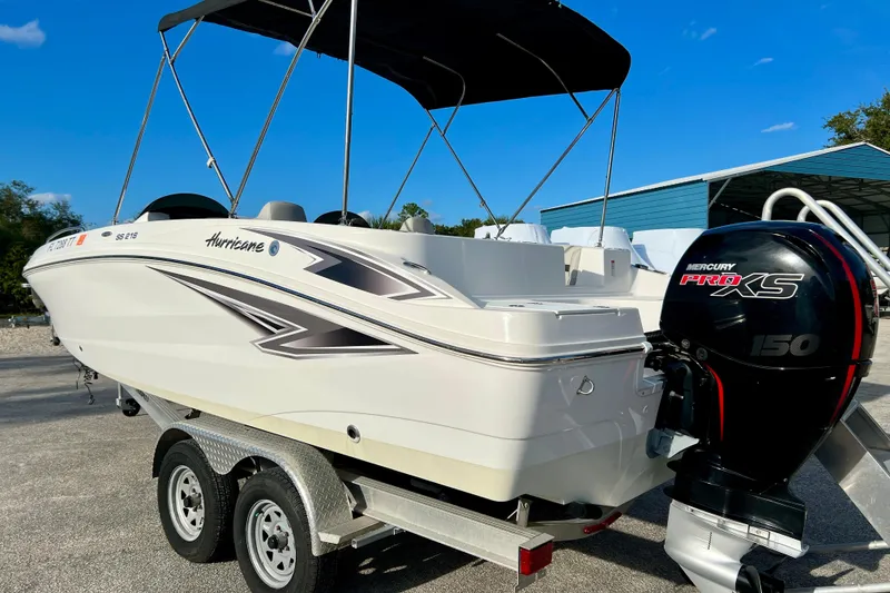 Slide: The Image of 2024 Hurricane Sundeck Sport 218 OB boat with Mercury Pro XS 150 engine on trailer. - 6