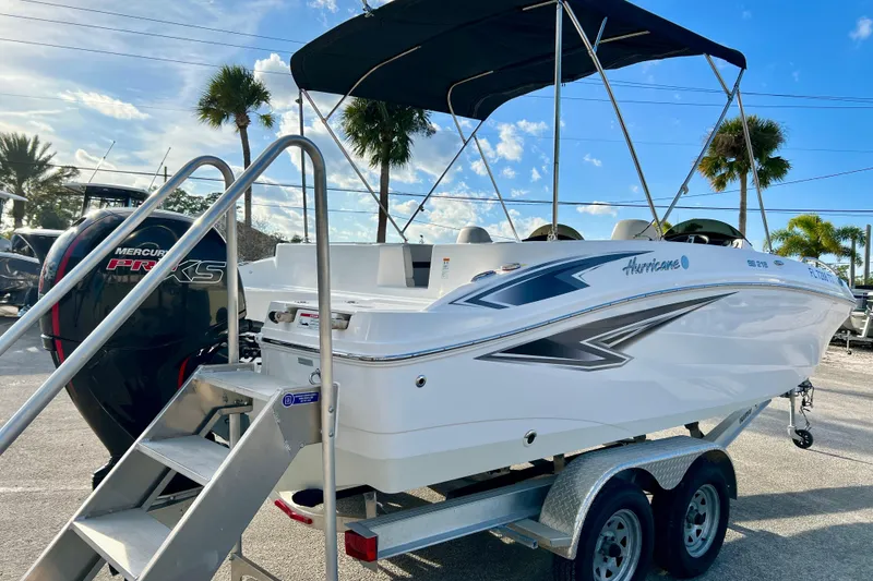 Slide: The Image of 2024 Hurricane Sundeck Sport 218 OB boat on trailer with Mercury engine. - 8