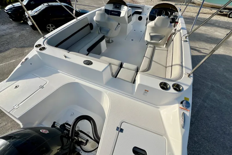 Slide: The Image of 2024 Hurricane Sundeck Sport 218 OB boat interior with seating and steering console. - 9
