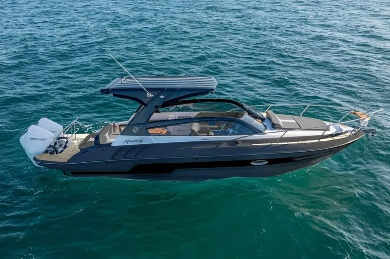 Slide: The Image of 2027 Hanover 305 boat cruising on open water, featuring sleek design and modern amenities. - 1