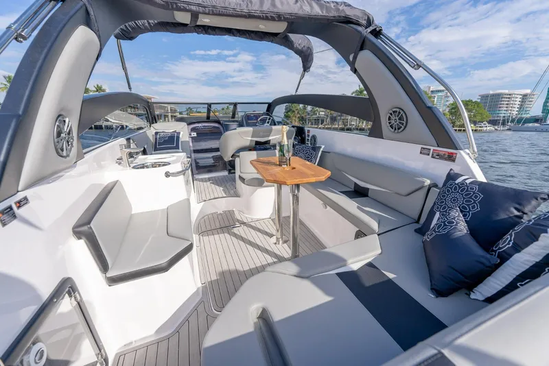 Slide: The Image of Luxurious 2027 Hanover 305 yacht interior with elegant seating and scenic waterfront view. - 10