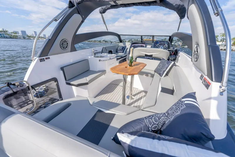 Slide: The Image of Luxurious 2027 Hanover 305 boat interior with elegant seating and a wooden table on the water. - 17
