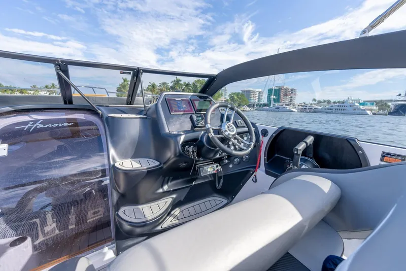 Slide: The Image of Interior view of a 2027 Hanover 305 boat cockpit with modern steering and controls. - 18