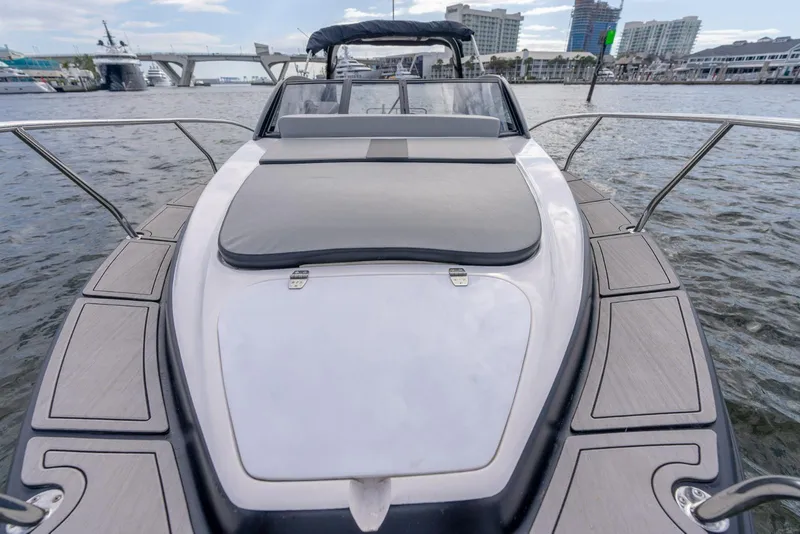 Slide: The Image of Luxury Hanover 305 yacht, 2027 model, docked in a marina with cityscape background. - 2
