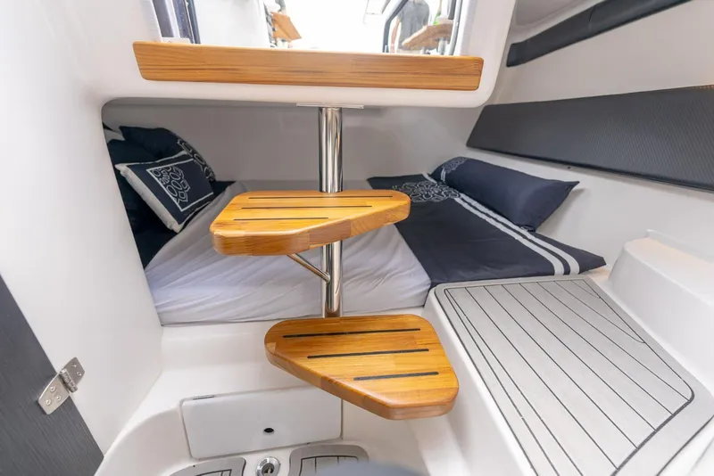 Slide: The Image of Interior of 2027 Hanover 305 boat with wooden steps and cozy sleeping area. - 8