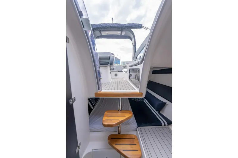 Slide: The Image of Interior view of 2027 Hanover 305 yacht, featuring wooden steps and sleek seating area. - 9