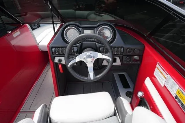 Slide: The Image of 2015 Moomba Mojo boat interior with red dashboard and steering wheel. - 14