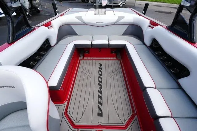 Slide: The Image of 2015 Moomba Mojo boat interior with red and gray seating and flooring. - 15