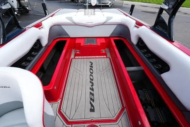 Slide: The Image of 2015 Moomba Mojo boat interior with red accents and spacious seating. - 16