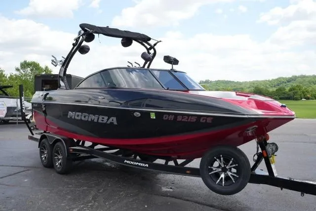 Slide: The Image of 2015 Moomba Mojo boat on trailer, black and red design, parked outdoors. - 3