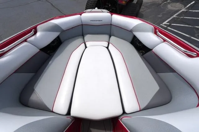 Slide: The Image of Interior seating of a 2015 Moomba Mojo boat, featuring gray and red upholstery. - 9