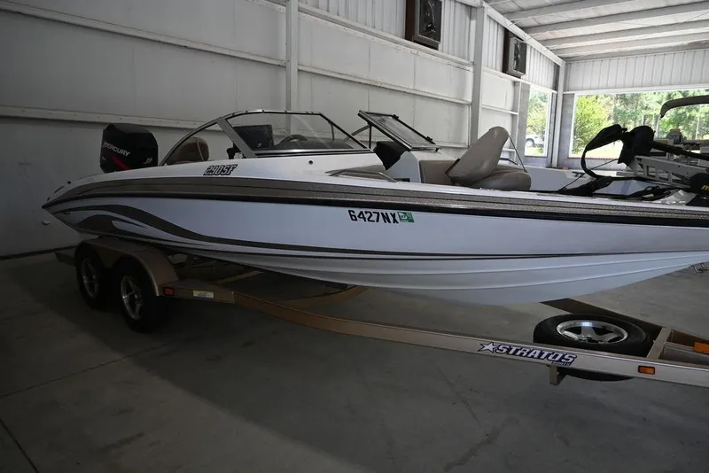 Slide: The Image of 2004 Stratos 290 Ski-N-Fish boat on trailer in indoor storage. - 10