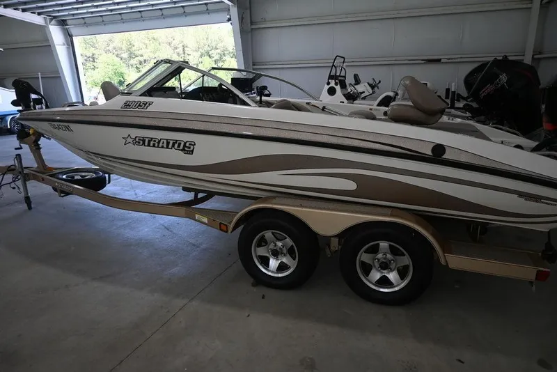 Slide: The Image of 2004 Stratos 290 Ski-N-Fish boat on trailer in garage setting. - 3