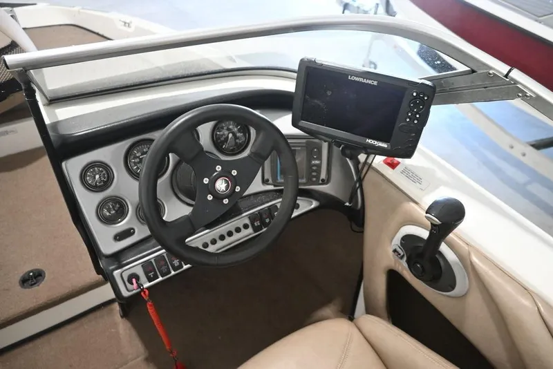 Slide: The Image of 2004 Stratos 290 Ski-N-Fish boat dashboard with steering wheel and Lowrance fish finder. - 4