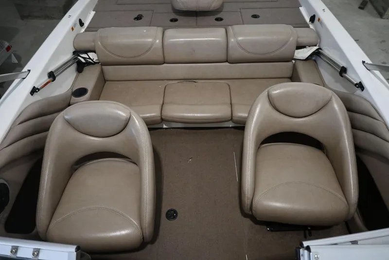 Slide: The Image of 2004 Stratos 290 Ski-N-Fish boat interior with beige seating and carpeted floor. - 7