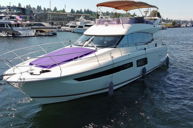 The Image of Luxurious 2017 Prestige 500 yacht docked in a marina, featuring sleek design and spacious deck. - 0