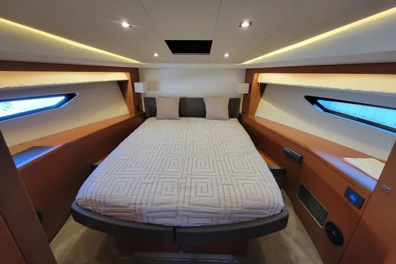 Slide: The Image of Luxurious cabin interior of a 2017 Prestige 500 yacht, featuring a comfortable bed and modern design. - 29