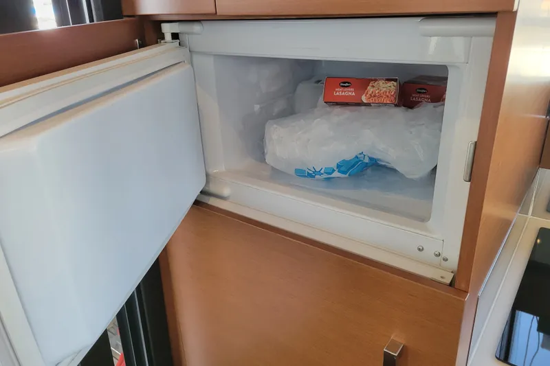Slide: The Image of Open freezer in Prestige 500 yacht, containing frozen lasagna and ice. - 45