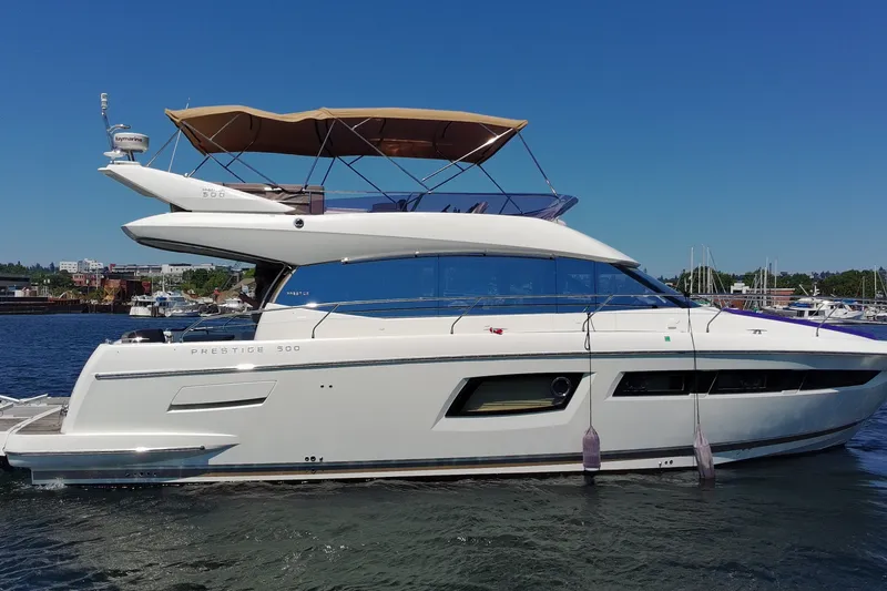 Slide: The Image of Luxury 2017 Prestige 500 yacht docked in a serene marina setting. - 4