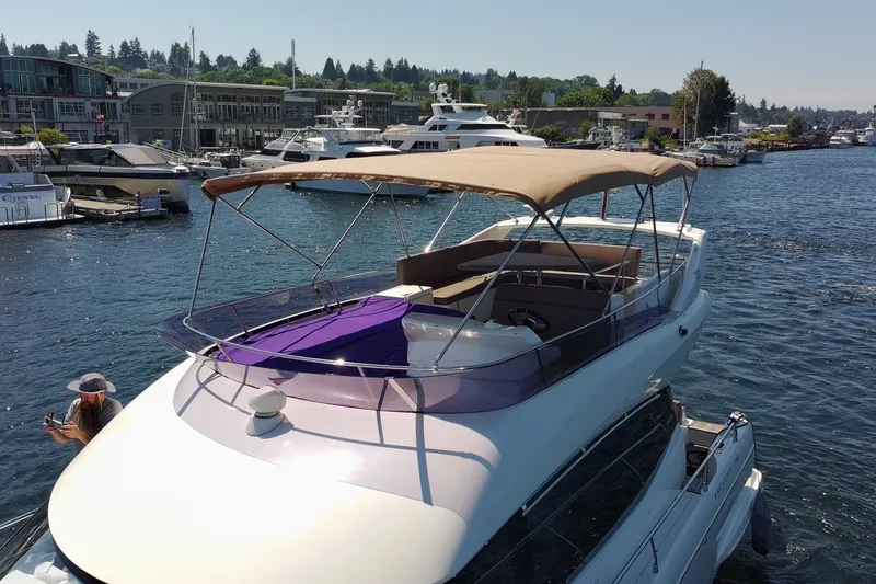 Slide: The Image of 2017 Prestige 500 yacht docked in a marina, featuring a spacious deck and canopy. - 8