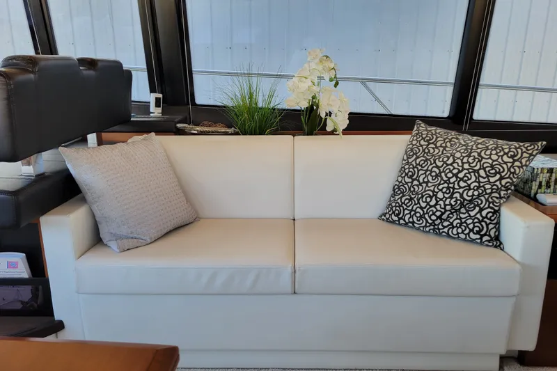 Slide: The Image of Luxurious interior of 2017 Prestige 500 yacht with elegant white sofa and decorative pillows. - 47