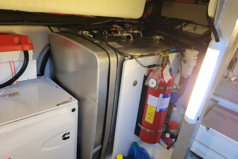 Slide: The Image of Engine room of a 2017 Prestige 500 yacht with equipment and fire extinguisher. - 53