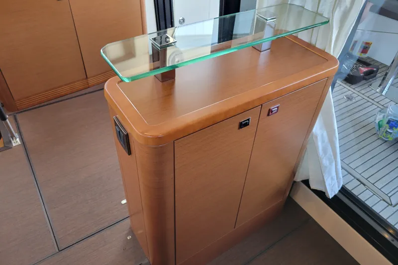 Slide: The Image of Wooden cabinet with glass top inside a 2017 Prestige 500 yacht interior. - 46