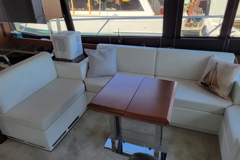 Slide: The Image of Luxurious interior of a 2017 Prestige 500 yacht with white seating and wooden table. - 13
