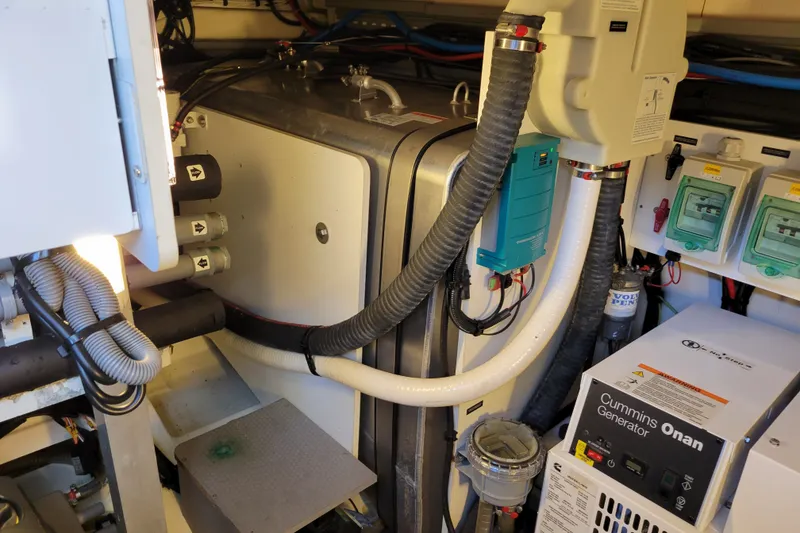 Slide: The Image of Engine room of a 2017 Prestige 500 yacht with Cummins Onan generator and various equipment. - 54