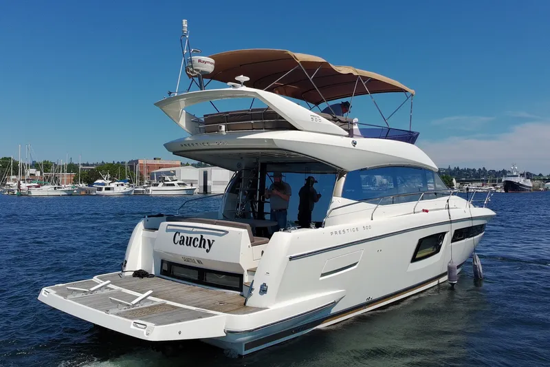 Slide: The Image of Luxury 2017 Prestige 500 yacht docked in a marina, featuring sleek design and spacious deck. - 3