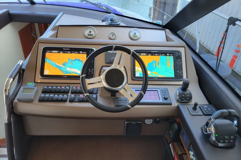 Slide: The Image of Cockpit of 2017 Prestige 500 yacht with dual navigation screens and controls. - 17