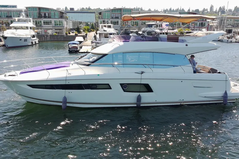 Slide: The Image of 2017 Prestige 500 yacht docked at marina, modern design, luxury waterfront living. - 1