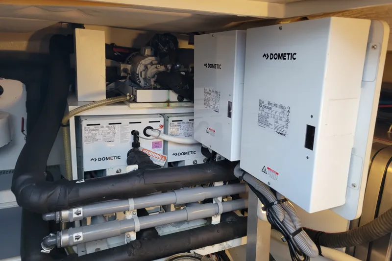 Slide: The Image of Engine room of a 2017 Prestige 500 yacht featuring Dometic equipment and piping systems. - 55