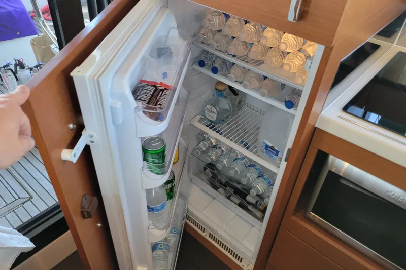Slide: The Image of Refrigerator stocked with drinks and snacks on a 2017 Prestige 500 yacht. - 44